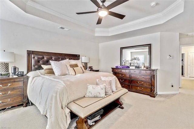 carpeted bedroom featuring crown molding, a raised ceiling, and ceiling fan