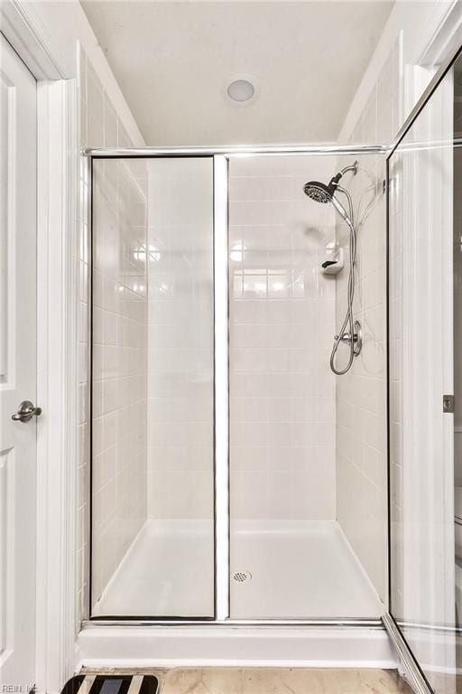 bathroom featuring tile patterned flooring and a shower with shower door