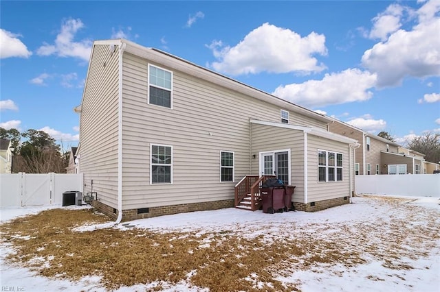 snow covered property with central AC unit