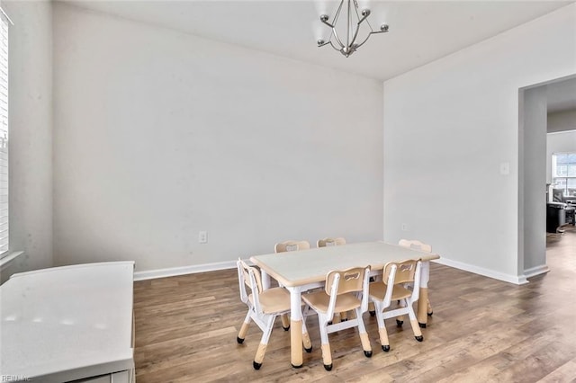 dining room featuring hardwood / wood-style flooring and a notable chandelier