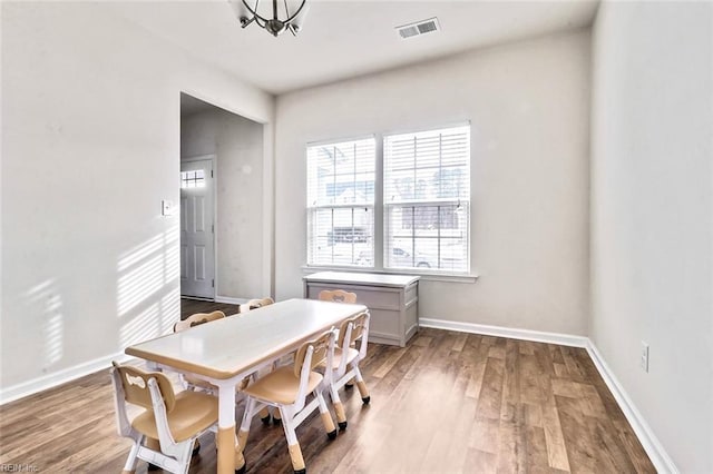 dining area featuring an inviting chandelier and light hardwood / wood-style floors