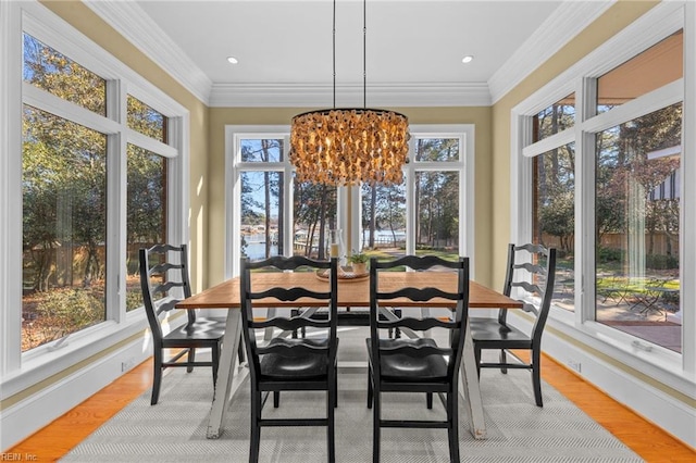 sunroom with plenty of natural light and an inviting chandelier