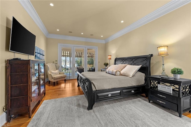 bedroom featuring ornamental molding, access to outside, and light hardwood / wood-style floors