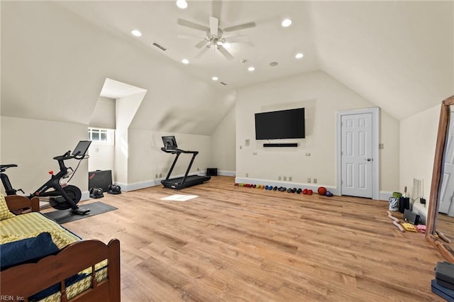 workout area with vaulted ceiling, ceiling fan, and light wood-type flooring