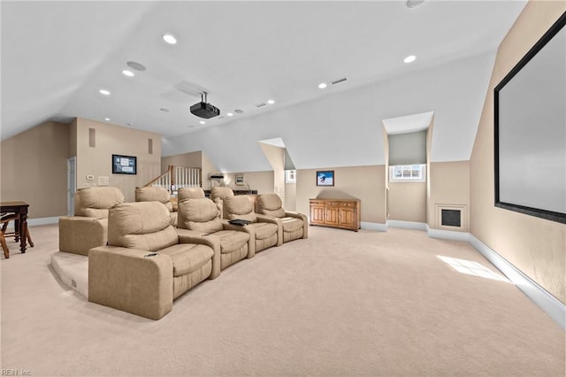 carpeted home theater room with lofted ceiling