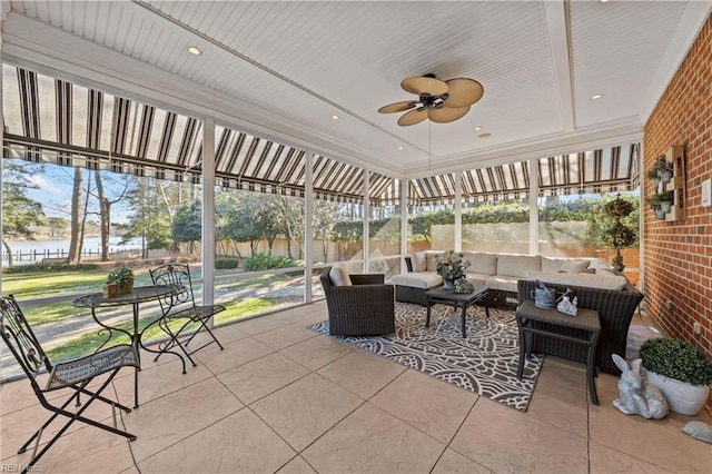 sunroom featuring ceiling fan