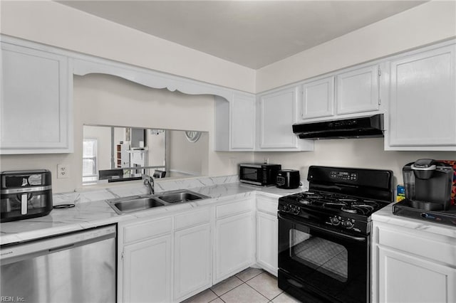 kitchen featuring sink, light tile patterned floors, black appliances, and white cabinets