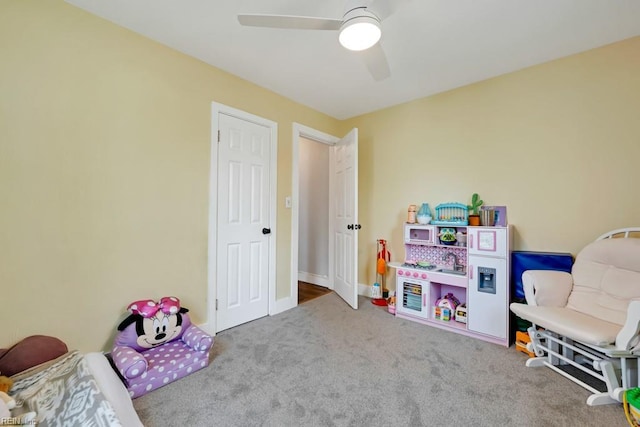 recreation room with carpet flooring and ceiling fan