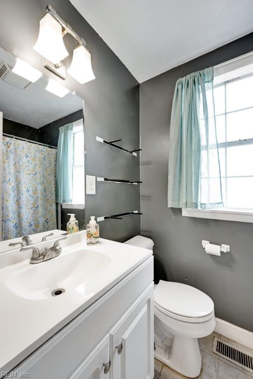 bathroom featuring vanity, tile patterned floors, and toilet