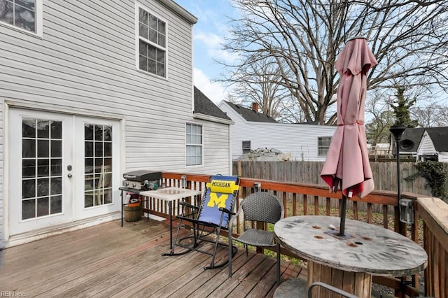 wooden terrace featuring area for grilling and french doors