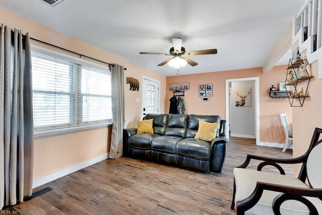 living room with hardwood / wood-style flooring and ceiling fan