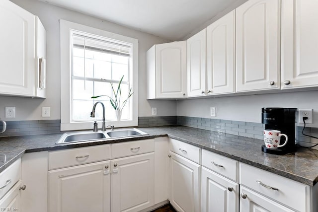 kitchen featuring sink and white cabinets