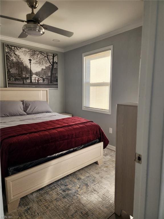 carpeted bedroom featuring ceiling fan and ornamental molding