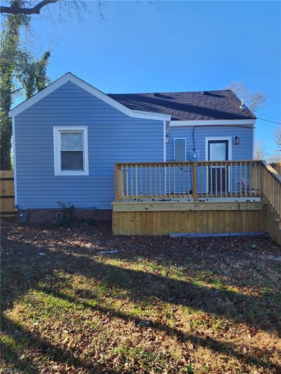 rear view of house featuring a wooden deck