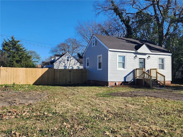 back of house with a lawn