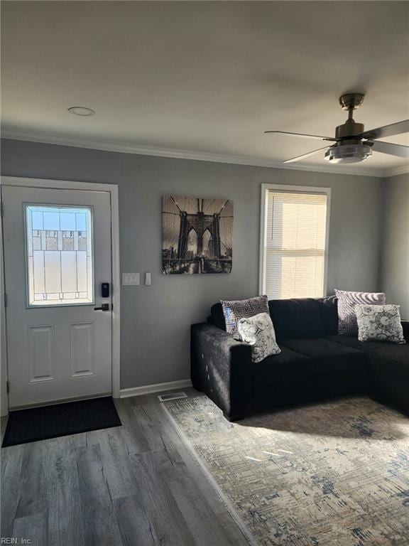 living room featuring ceiling fan, ornamental molding, and hardwood / wood-style floors