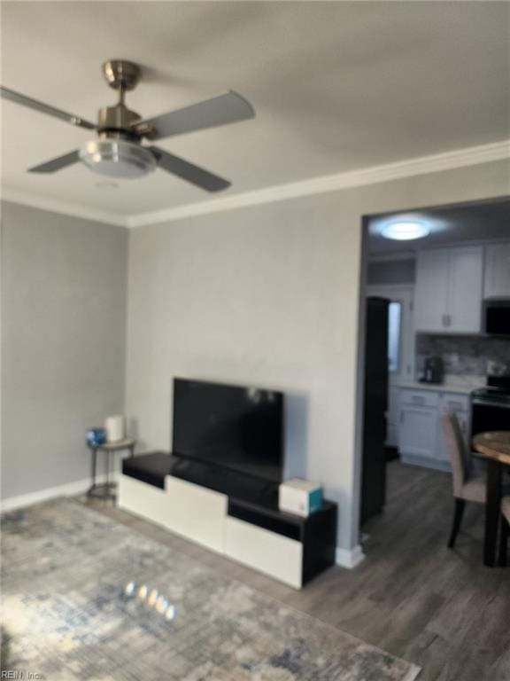 living room featuring ornamental molding, ceiling fan, and dark hardwood / wood-style flooring