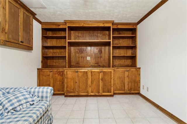 tiled living room with built in shelves, crown molding, and a textured ceiling