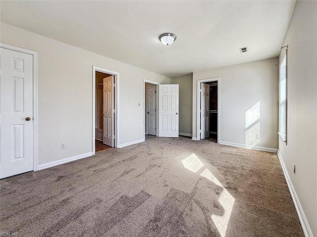 unfurnished bedroom featuring carpet and ensuite bath