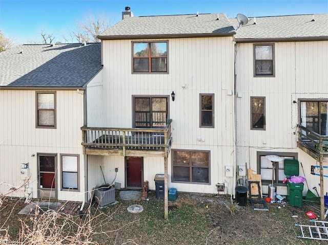 rear view of house featuring central AC