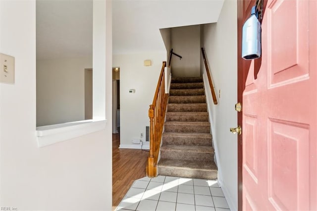 stairway with tile patterned floors