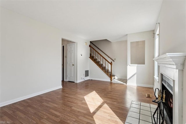 unfurnished living room with hardwood / wood-style floors