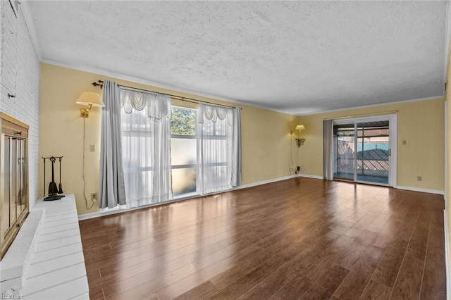 unfurnished living room featuring hardwood / wood-style flooring and a textured ceiling