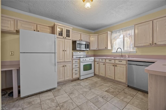 kitchen with sink, ornamental molding, a textured ceiling, and appliances with stainless steel finishes