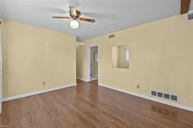 empty room with hardwood / wood-style floors and ceiling fan