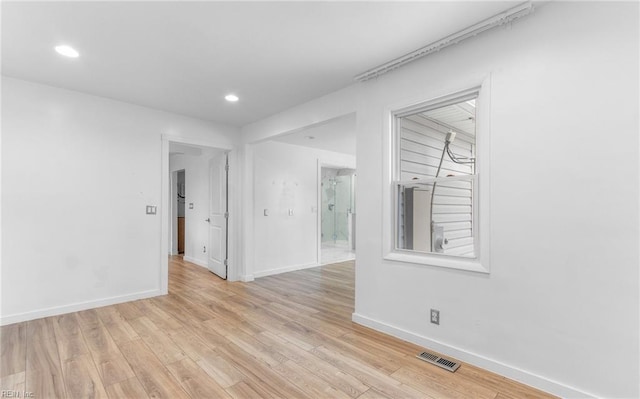 spare room featuring light wood-type flooring