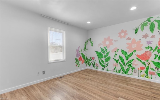 spare room with light hardwood / wood-style flooring