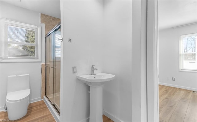 bathroom with sink, wood-type flooring, toilet, and walk in shower