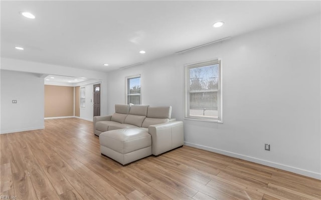 living room with a wealth of natural light and light wood-type flooring