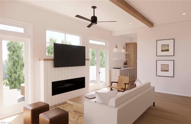 living room with beamed ceiling, a fireplace, a wealth of natural light, and light wood-type flooring