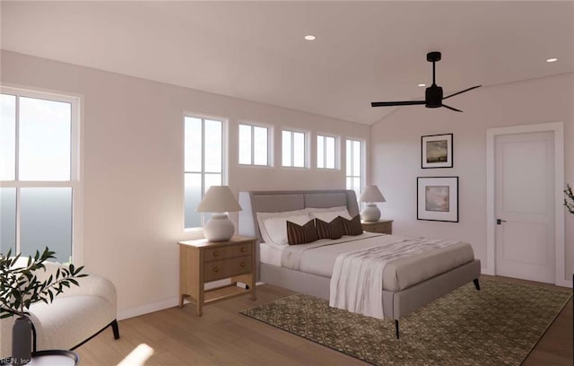 bedroom with multiple windows, ceiling fan, vaulted ceiling, and light hardwood / wood-style flooring