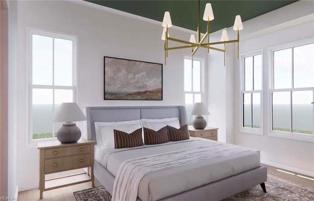 bedroom with a notable chandelier and light wood-type flooring