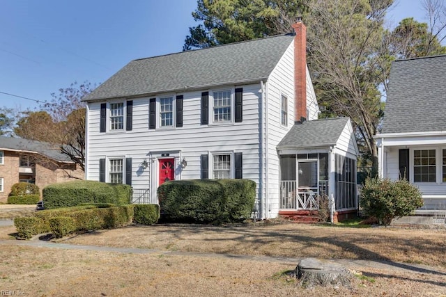 colonial home featuring a sunroom