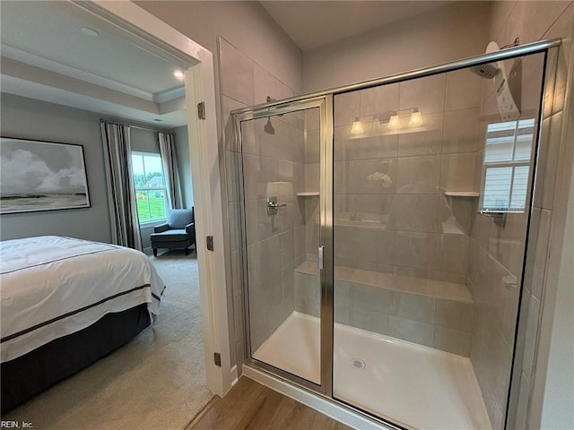 bathroom with wood-type flooring and a shower with shower door