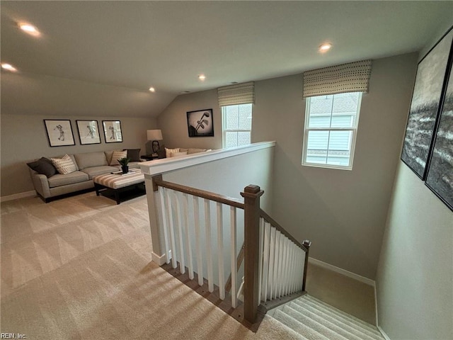 staircase with lofted ceiling and carpet flooring