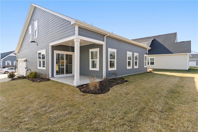 back of house with a patio area and a lawn