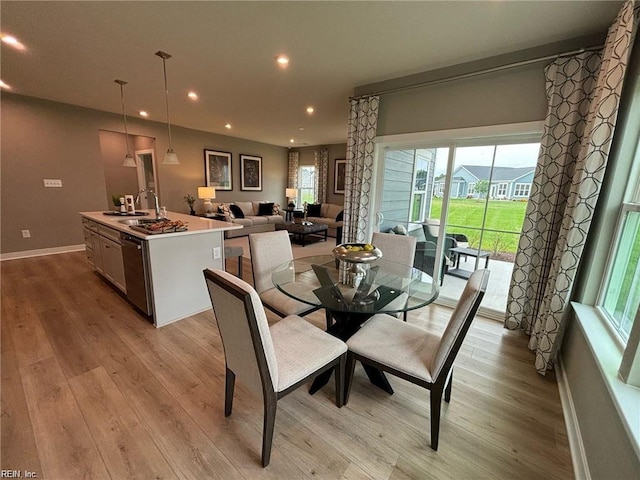 dining area featuring sink, plenty of natural light, and light hardwood / wood-style floors