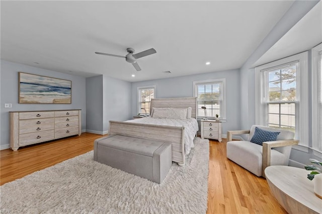 bedroom with ceiling fan and light wood-type flooring