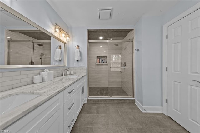 bathroom with tasteful backsplash, vanity, and a shower with shower door