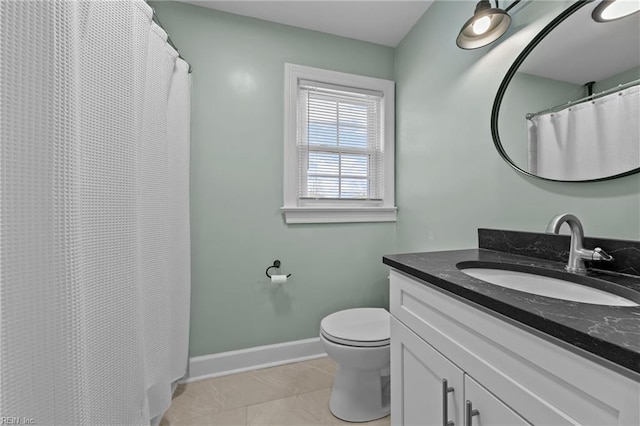 bathroom with vanity, toilet, and tile patterned flooring