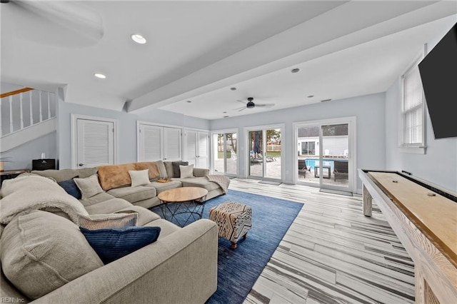 living room with ceiling fan and light wood-type flooring