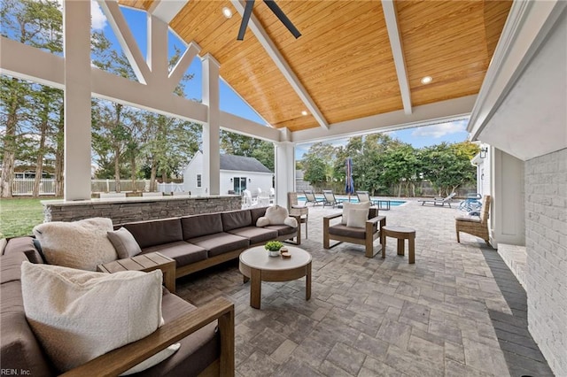 view of patio / terrace with an outdoor living space, a fenced in pool, and ceiling fan