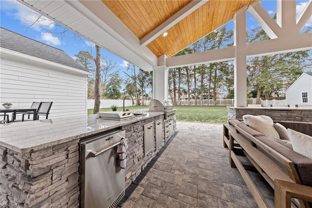 view of patio featuring an outdoor kitchen, area for grilling, and an outdoor hangout area