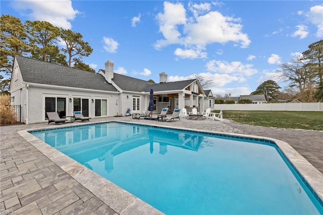 view of pool featuring a patio and an outdoor fire pit