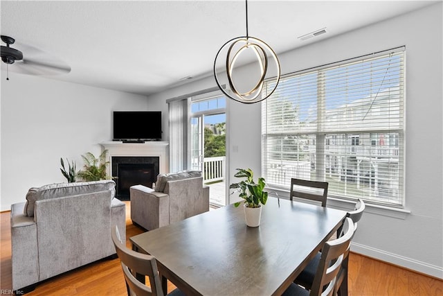 dining area featuring a healthy amount of sunlight, hardwood / wood-style floors, and ceiling fan