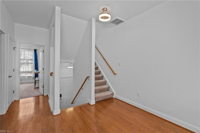 stairway with hardwood / wood-style flooring